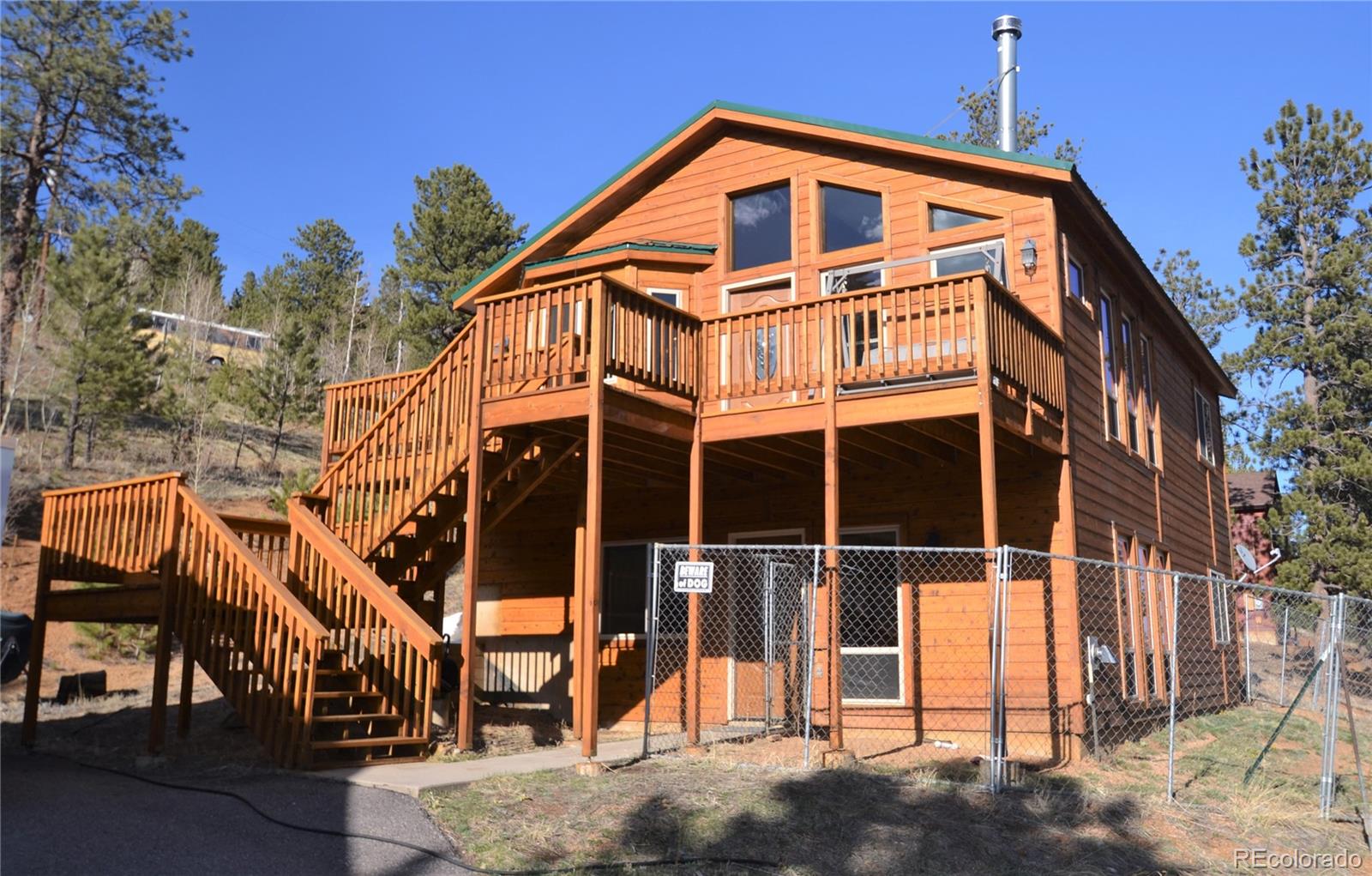 627 North Random Road Bailey, CO 80421 - Photo 1 of 15 a front view of a house with a yard