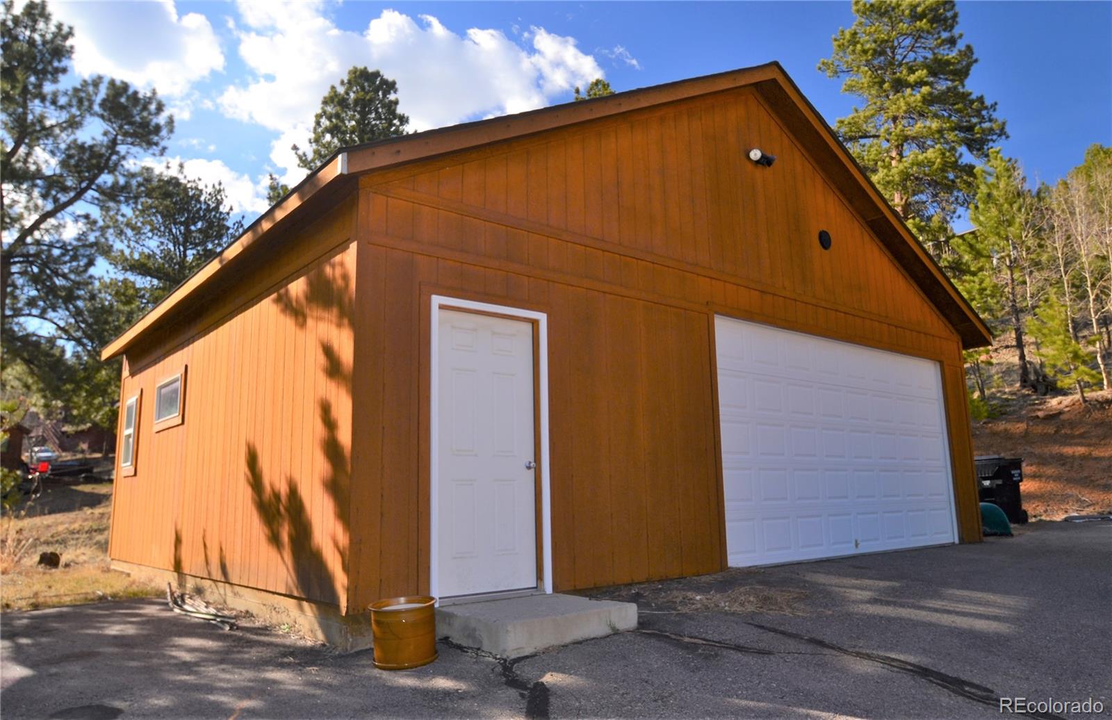 627 North Random Road Bailey, CO 80421 - Photo 4 of 15 a view of a house with a backyard