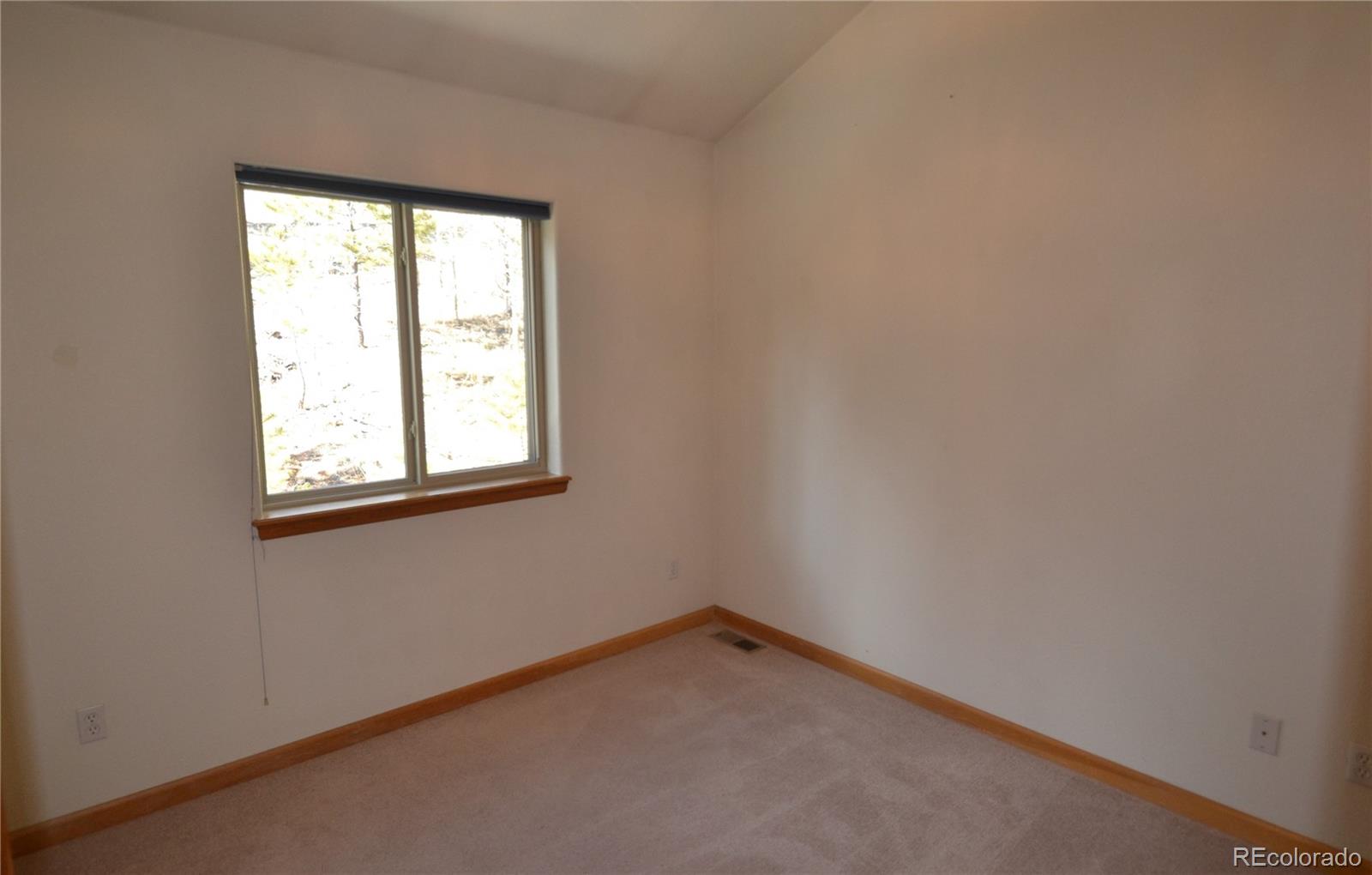 627 North Random Road Bailey, CO 80421 - Photo 10 of 15 an empty room with a window