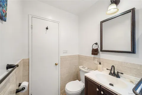 a bathroom with a toilet sink and mirror