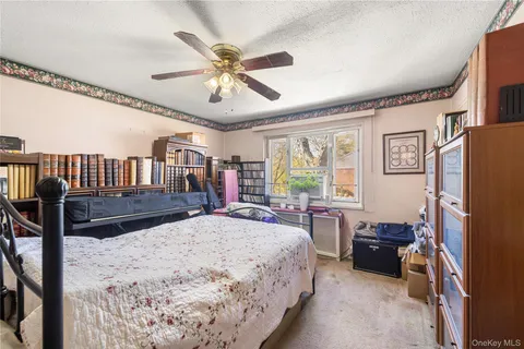 a bedroom with a bed furniture and a large window