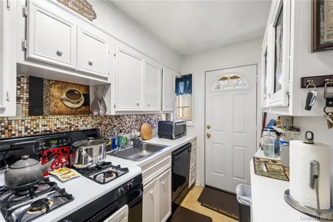 a kitchen with stainless steel appliances a stove a cabinets and a counter top space