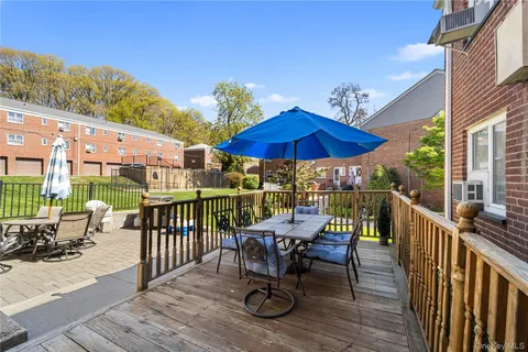a view of balcony with outdoor seating and wooden floor