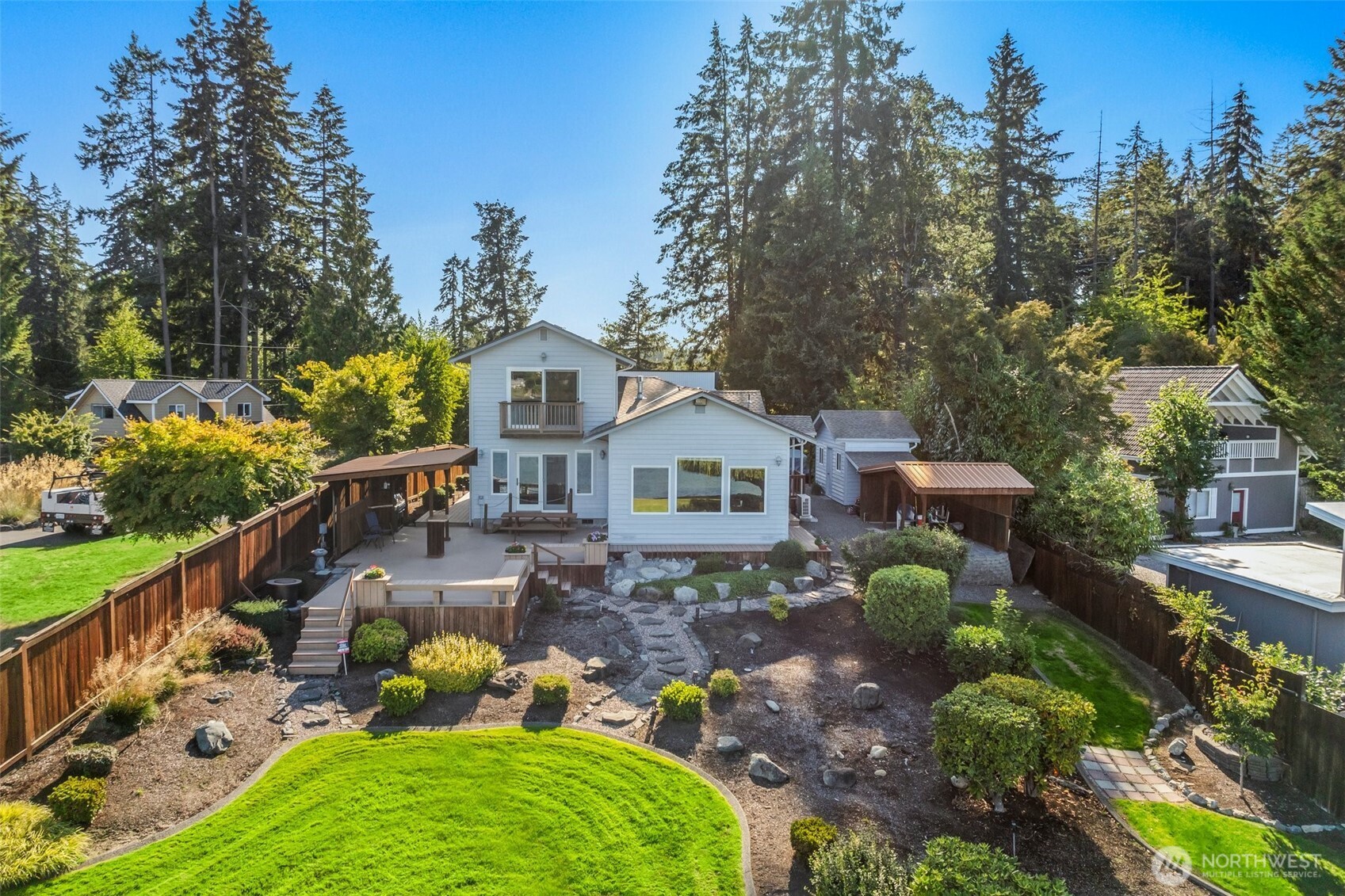 a aerial view of a house with a big yard and potted plants