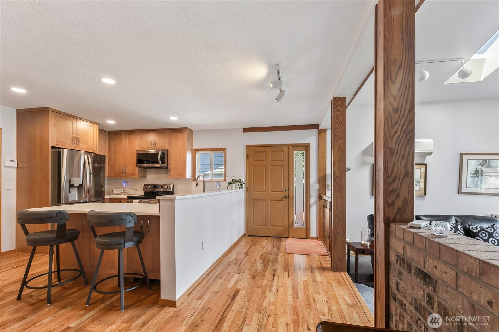 1207 Creso Road South Spanaway, WA 98387 - Photo 9 of 40 a kitchen with stainless steel appliances granite countertop a refrigerator a stove top oven a sink dishwasher and white cabinets with wooden floor