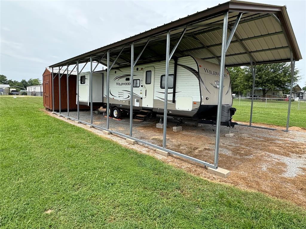 217 Wichita Quitman, TX 75783 - Photo 3 of 17 a view of a chair and table under an umbrella
