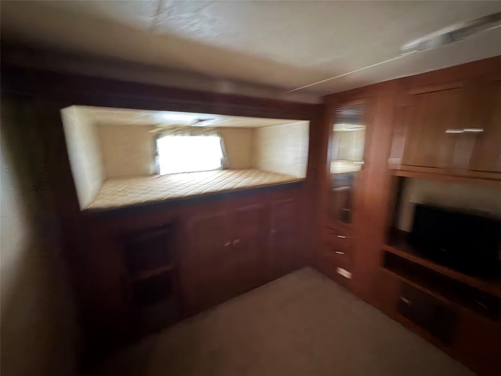217 Wichita Quitman, TX 75783 - Photo 9 of 17 a kitchen with a sink and a mirror