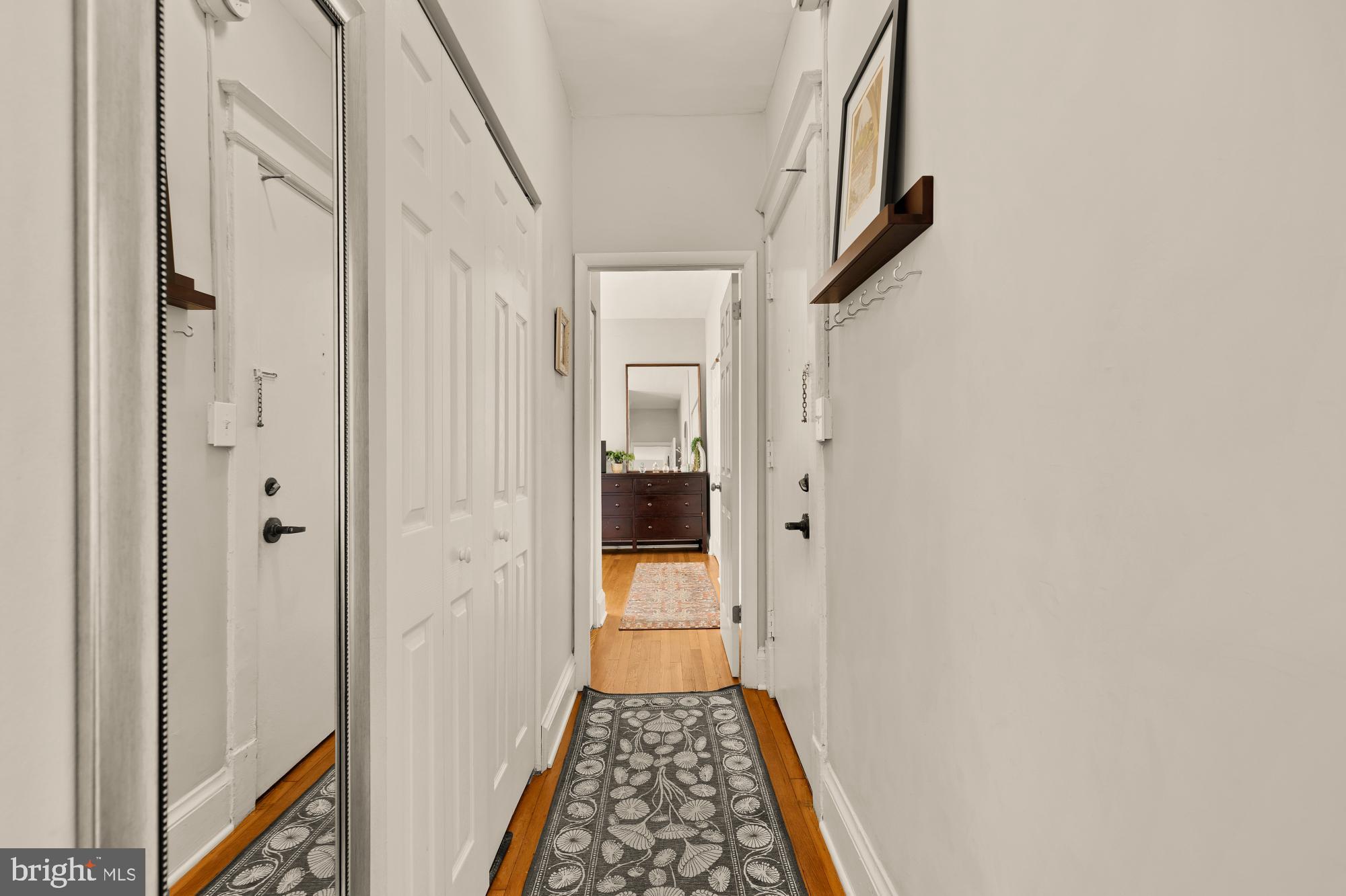 3022 Wisconsin Avenue Northwest, Unit 208 Washington, DC 20016 - Photo 12 of 24 a view of hallway with wooden floor and stairs
