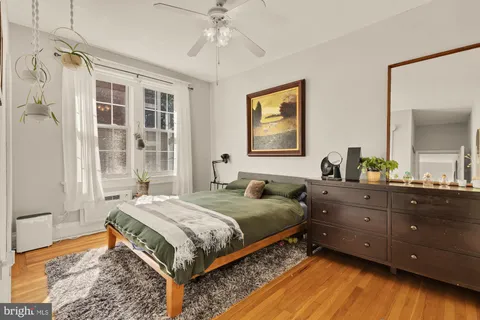 a view of hallway with wooden floor and stairs