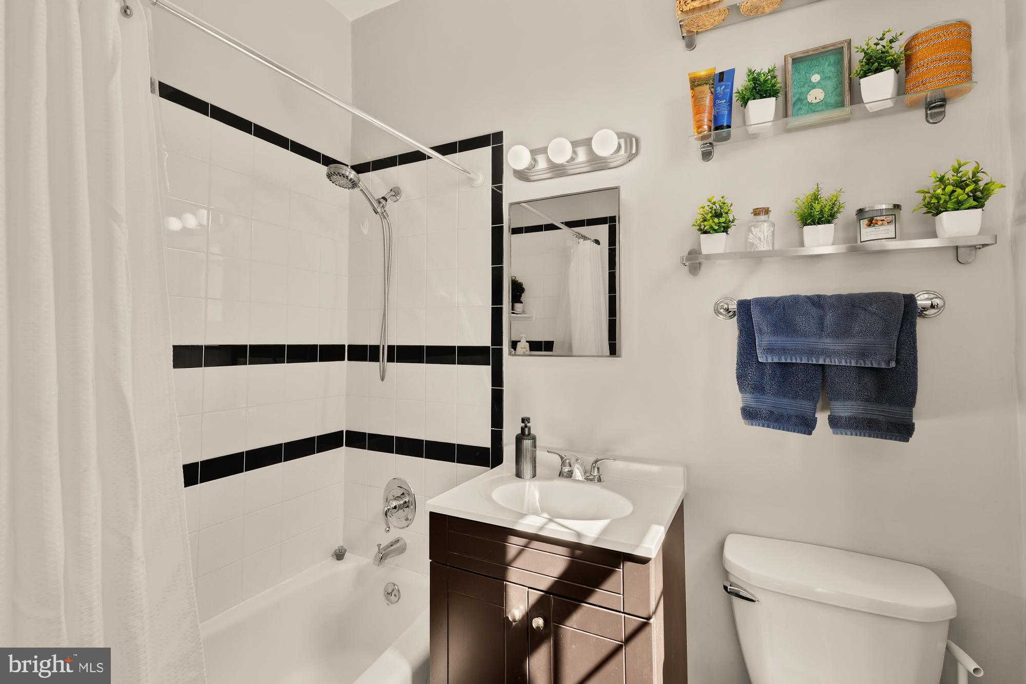 3022 Wisconsin Avenue Northwest, Unit 208 Washington, DC 20016 - Photo 16 of 24 a bathroom with a sink a toilet and shower