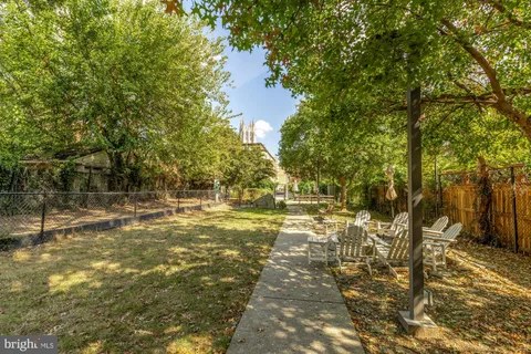 a view of a lake with tables and chairs
