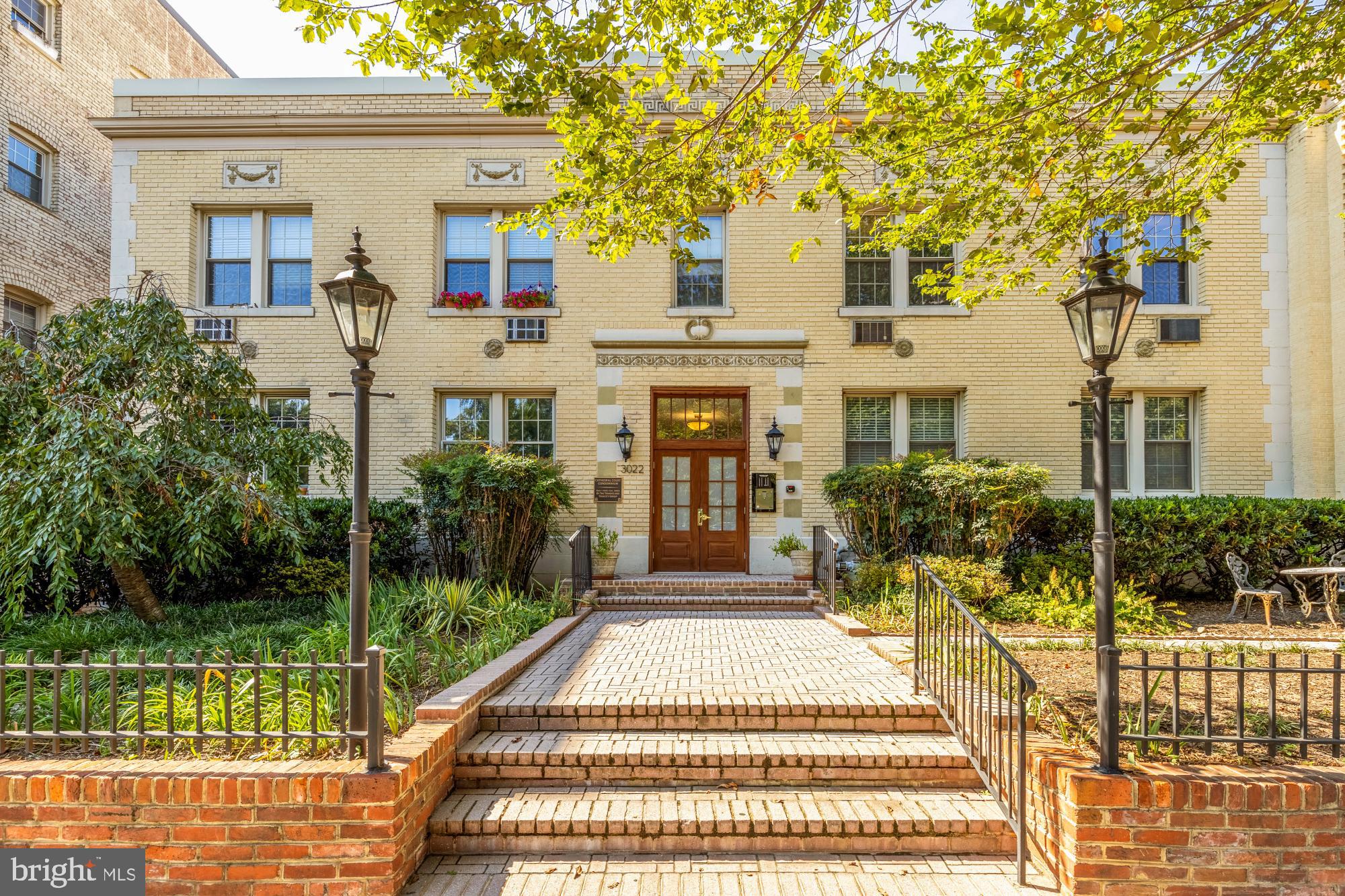 3022 Wisconsin Avenue Northwest, Unit 208 Washington, DC 20016 - Photo 3 of 24 a front view of a house with a yard