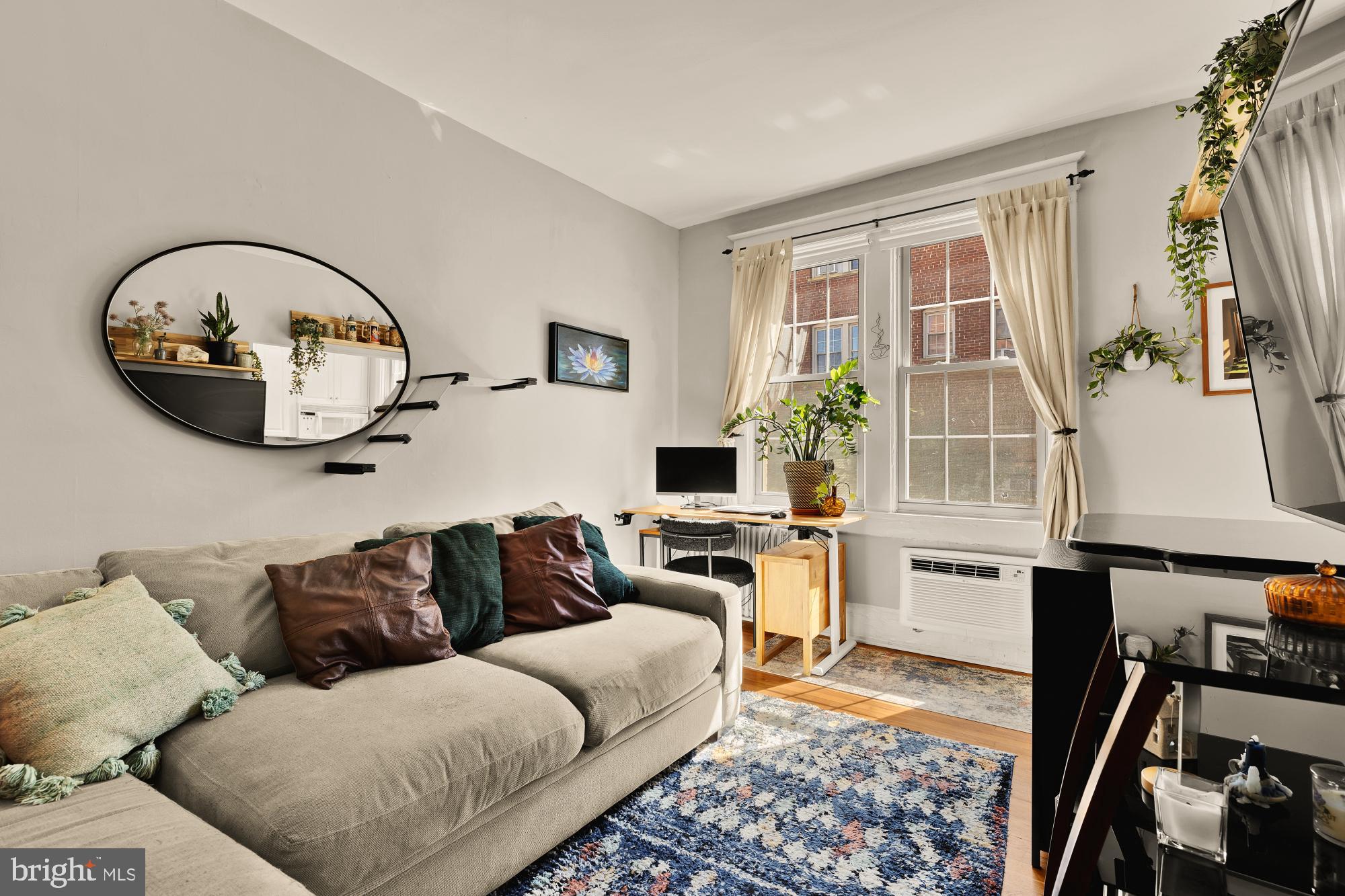 3022 Wisconsin Avenue Northwest, Unit 208 Washington, DC 20016 - Photo 5 of 24 a living room with furniture and a window