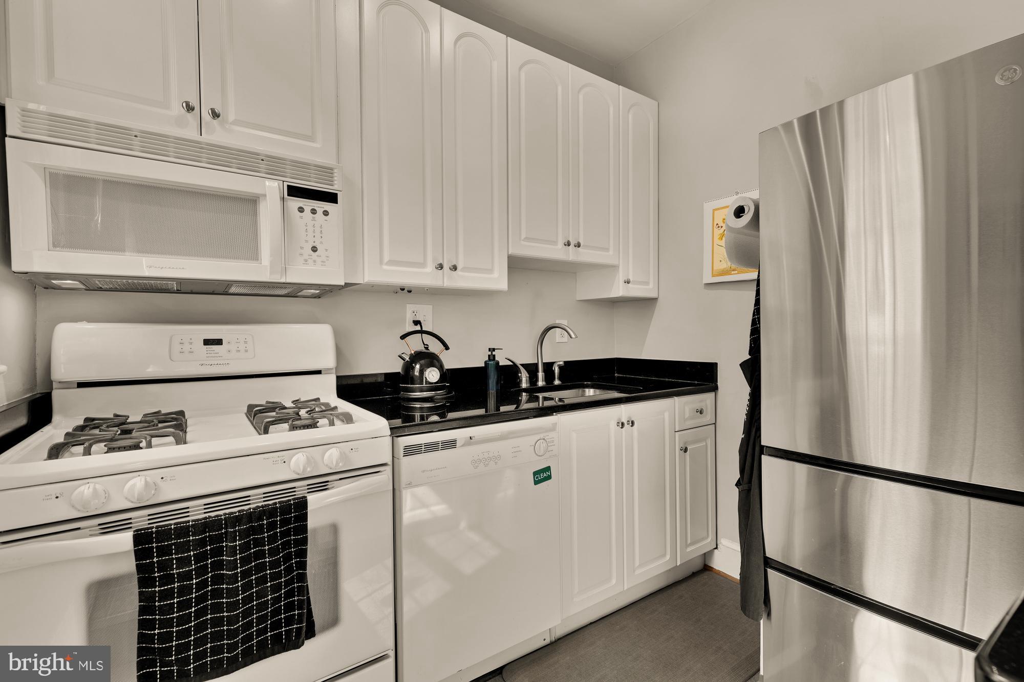 3022 Wisconsin Avenue Northwest, Unit 208 Washington, DC 20016 - Photo 8 of 24 a kitchen with stainless steel appliances a refrigerator sink and cabinets