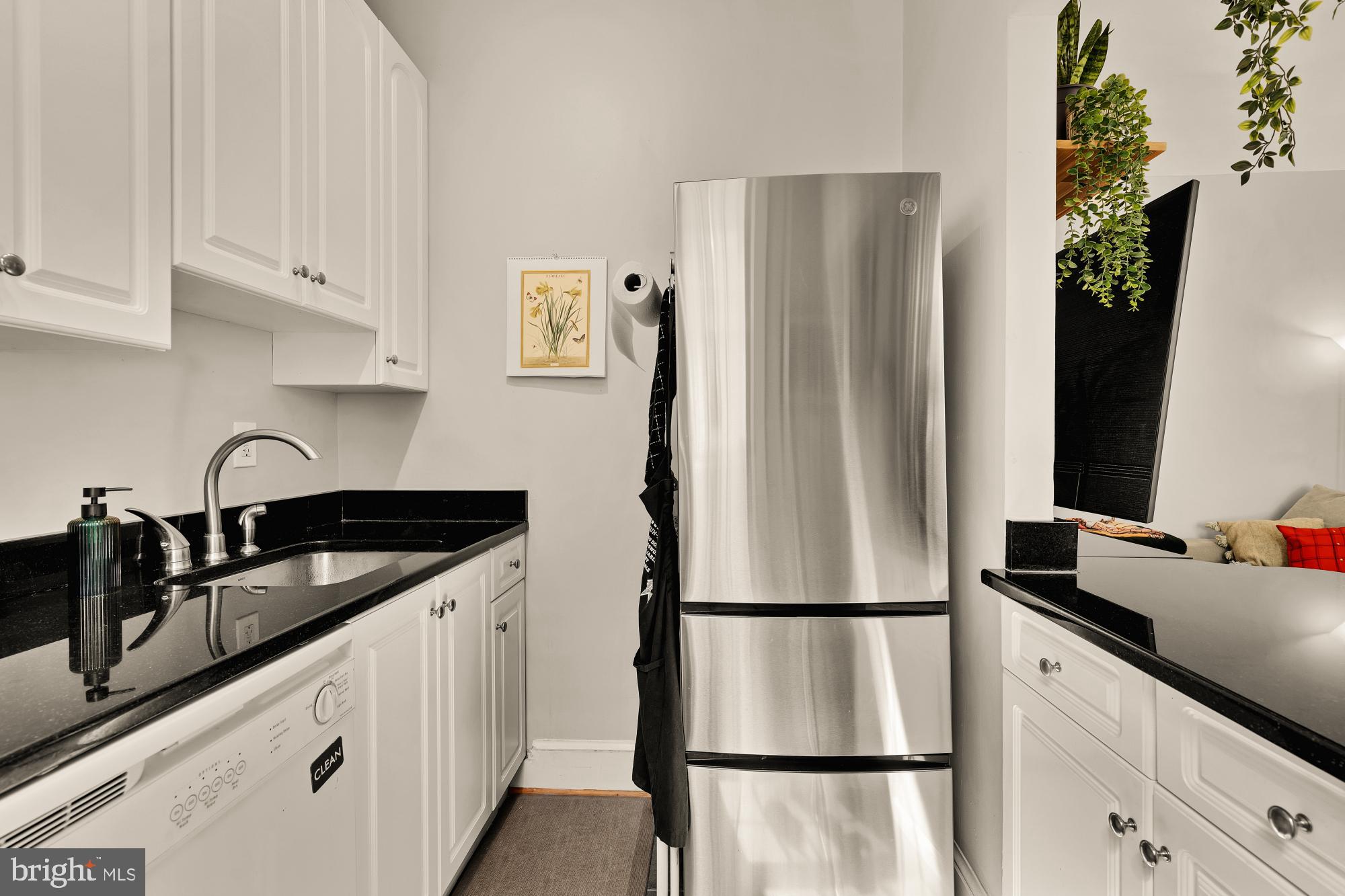 3022 Wisconsin Avenue Northwest, Unit 208 Washington, DC 20016 - Photo 9 of 24 a kitchen with appliances a refrigerator and white cabinets