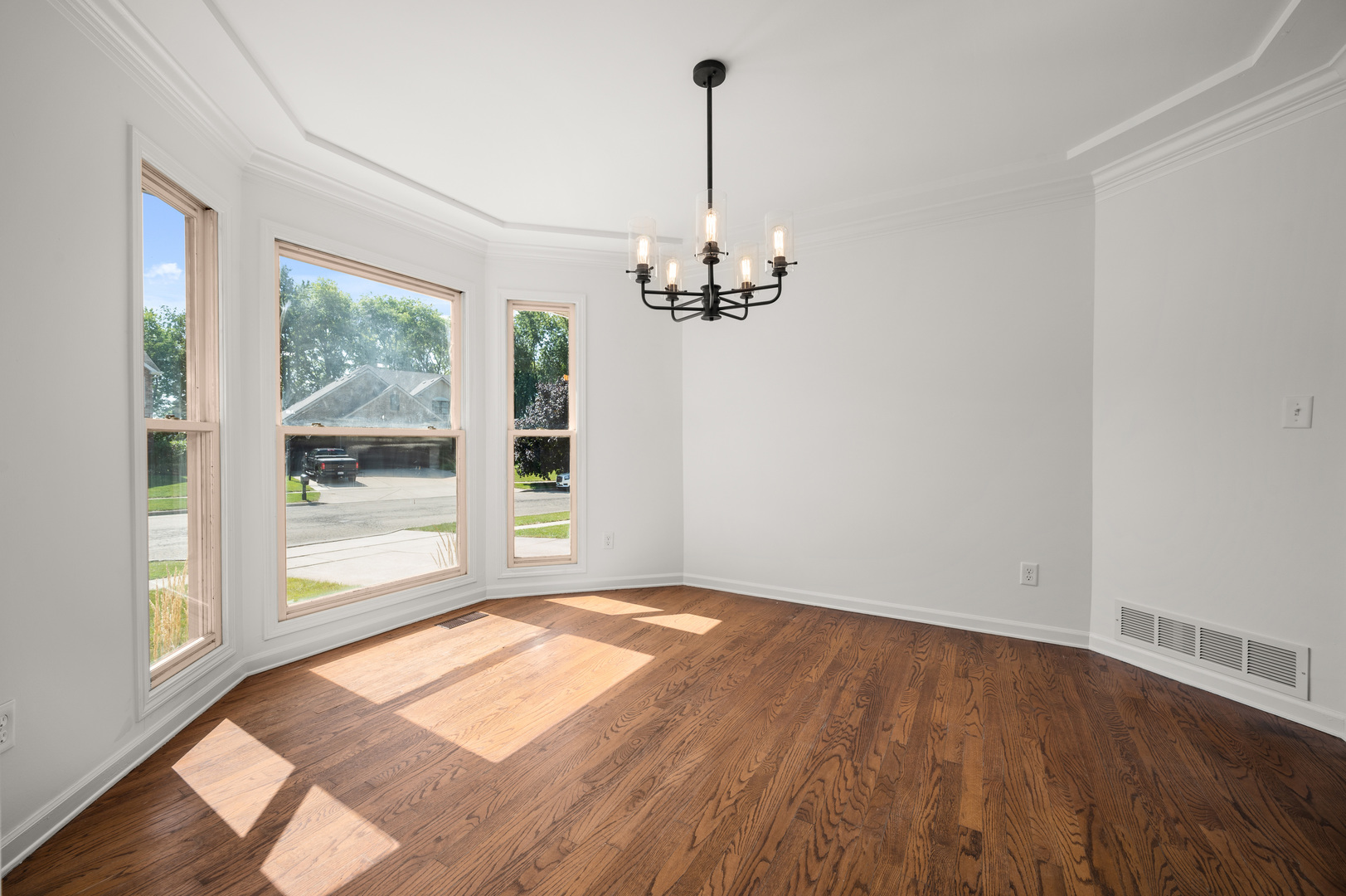649 Fox Hollow Court DeKalb, IL 60115 - Photo 11 of 38 a view of a room with wooden floor chandeliers and kitchen view