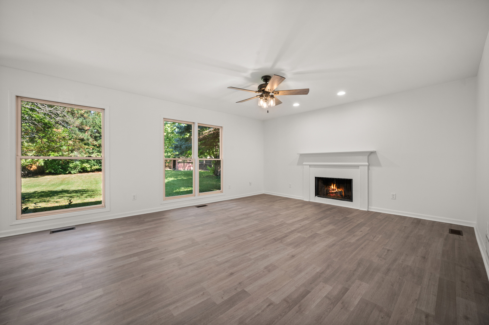 649 Fox Hollow Court DeKalb, IL 60115 - Photo 12 of 38 a view of an empty room with wooden floor and a window