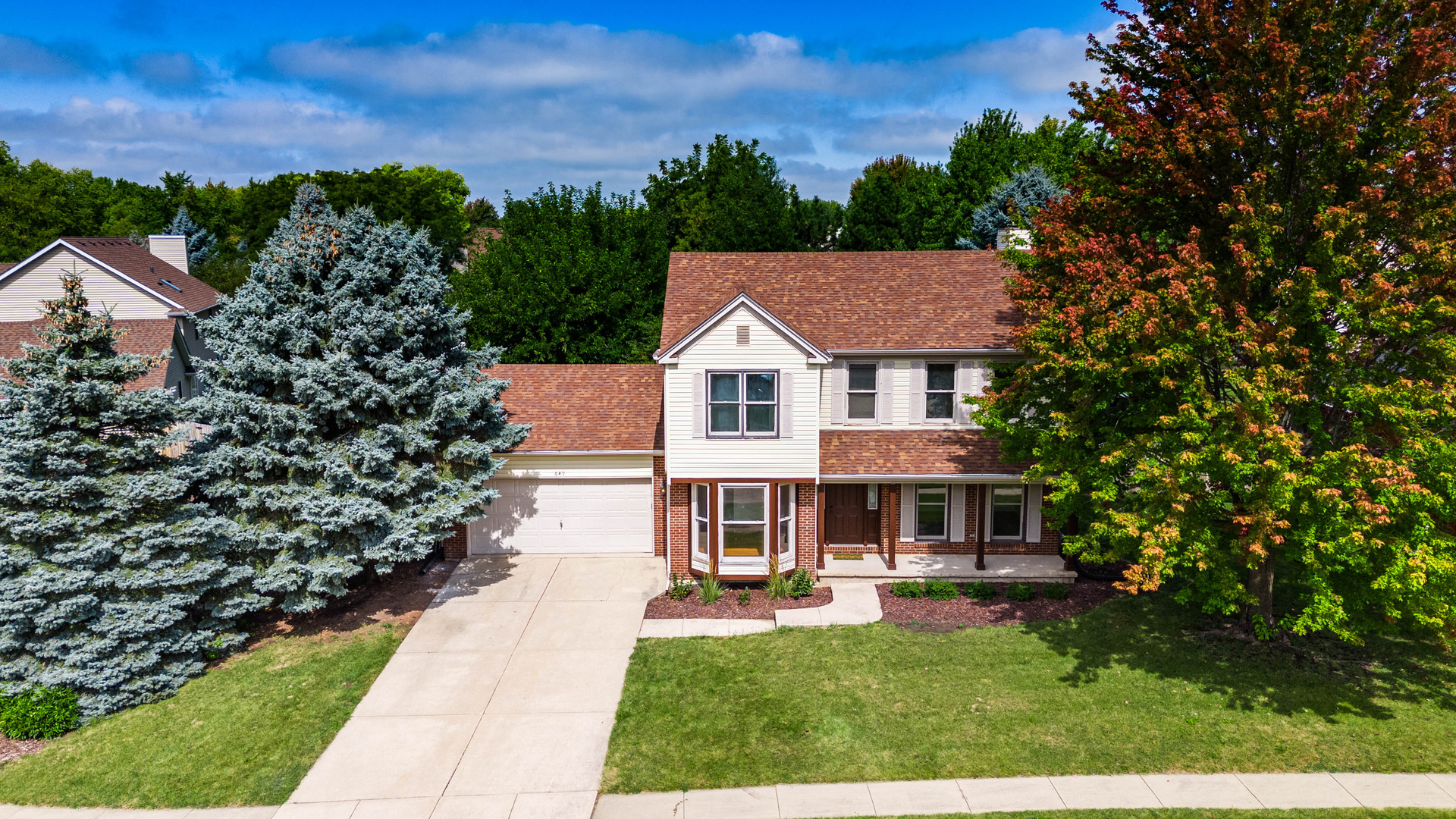 649 Fox Hollow Court DeKalb, IL 60115 - Photo 2 of 38 a front view of a house with a yard
