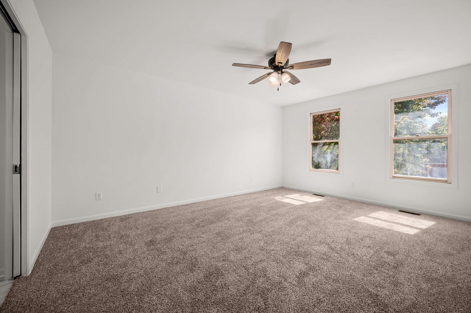 649 Fox Hollow Court DeKalb, IL 60115 - Photo 21 of 38 an empty room with windows and fan