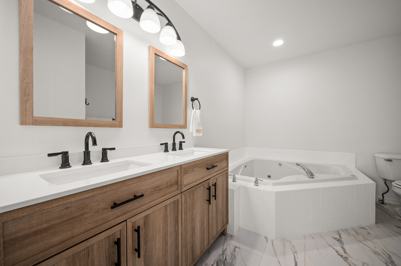 649 Fox Hollow Court DeKalb, IL 60115 - Photo 22 of 38 a bathroom with a white tub a sink and mirror