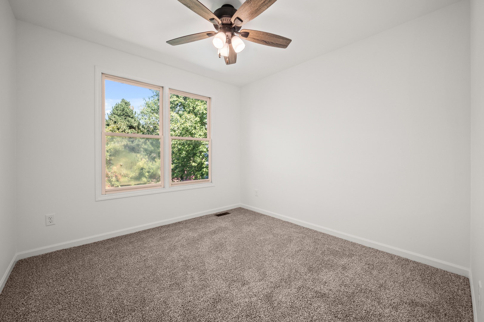 649 Fox Hollow Court DeKalb, IL 60115 - Photo 25 of 38 an empty room with windows and fan