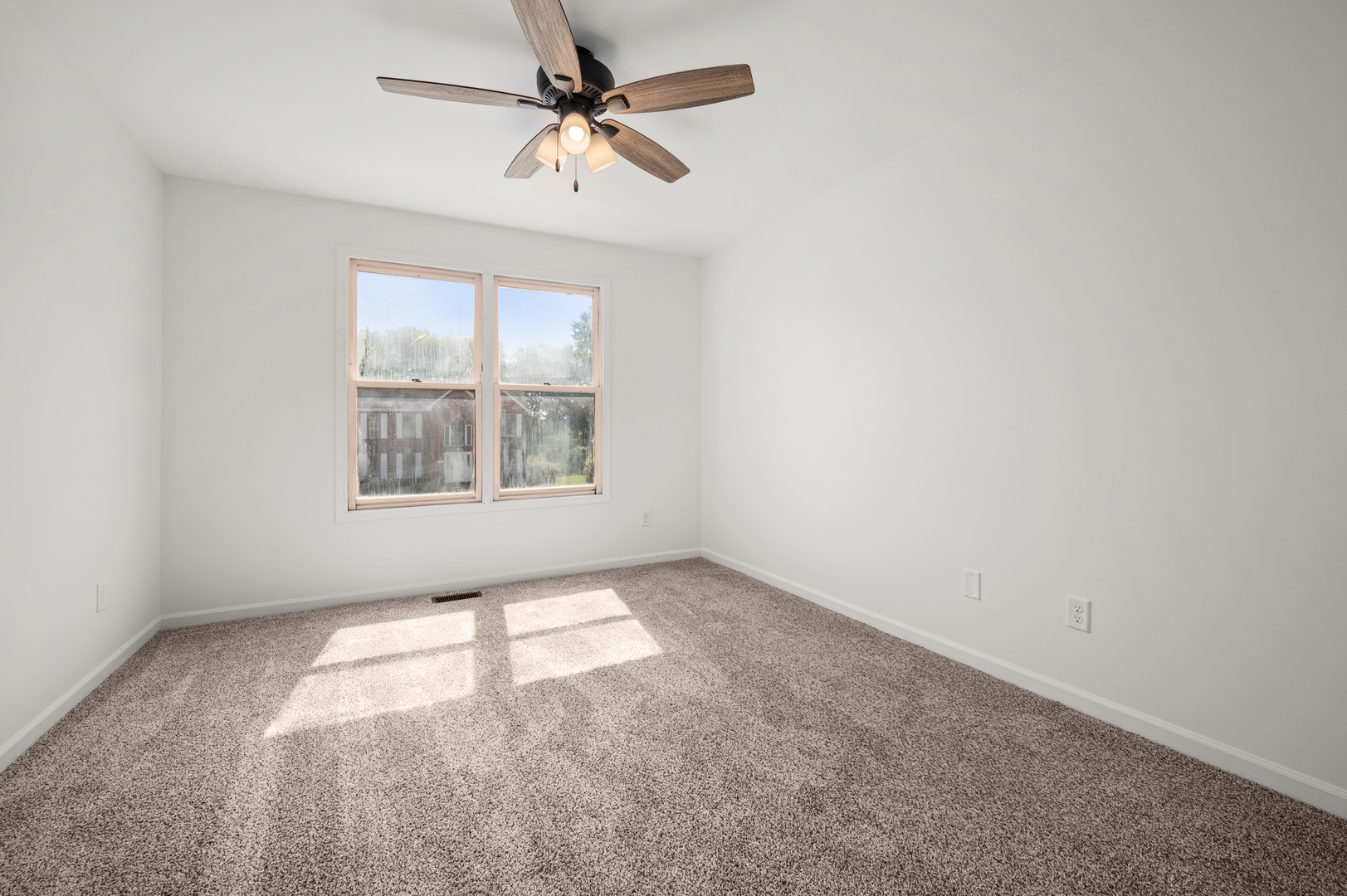 649 Fox Hollow Court DeKalb, IL 60115 - Photo 27 of 38 an empty room with windows and fan