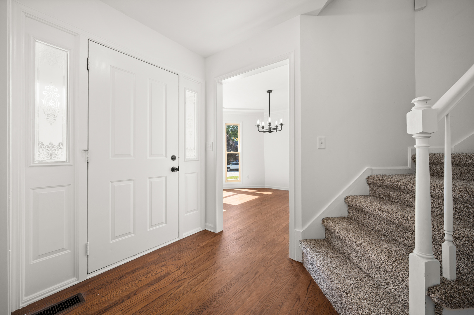 649 Fox Hollow Court DeKalb, IL 60115 - Photo 10 of 38 a view of entryway with wooden floor and staircase