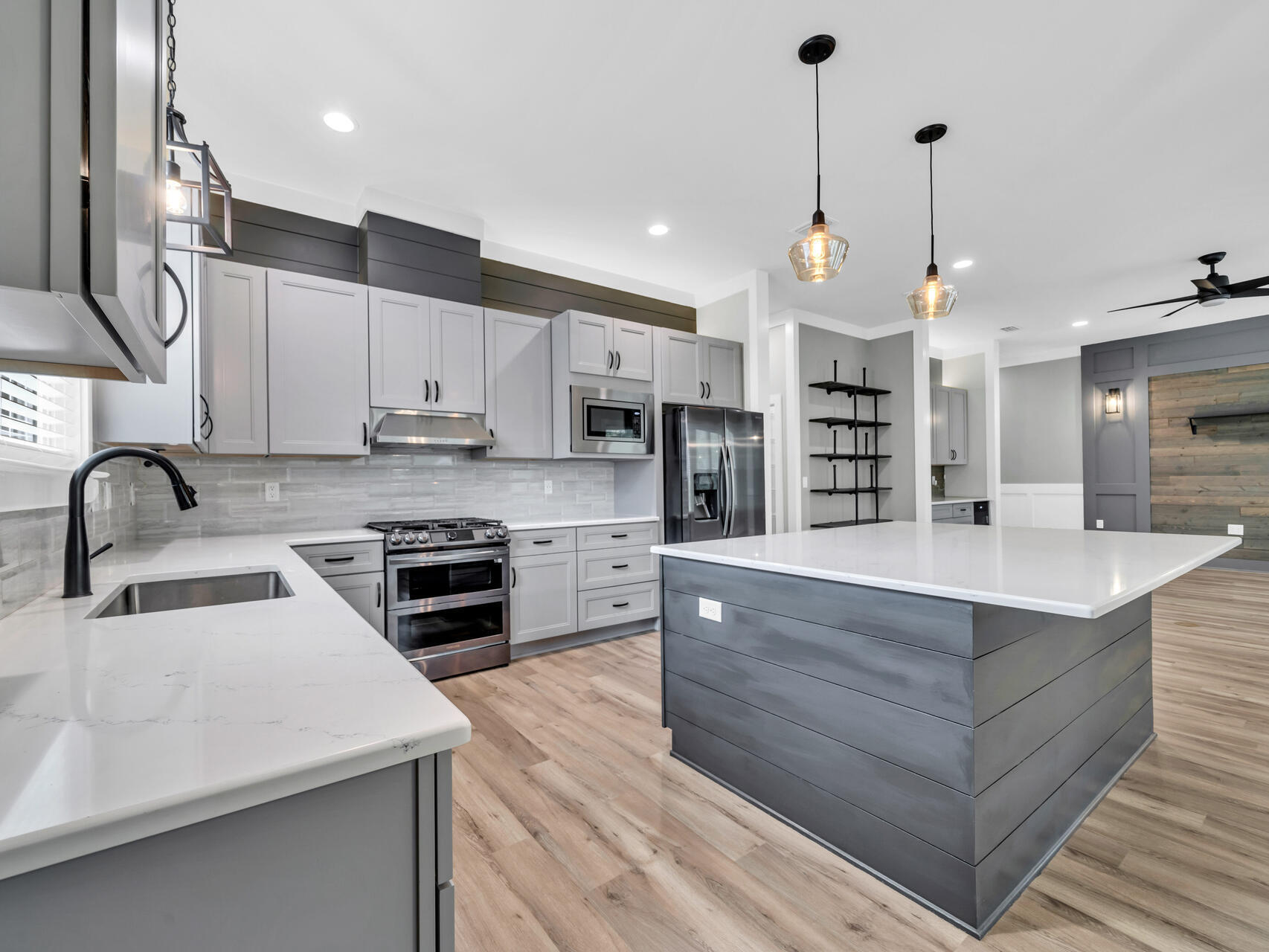 1160 Deer Moss Loop Niceville, FL 32578 - Photo 12 of 60 a kitchen with stainless steel appliances granite countertop a sink a stove and a kitchen island