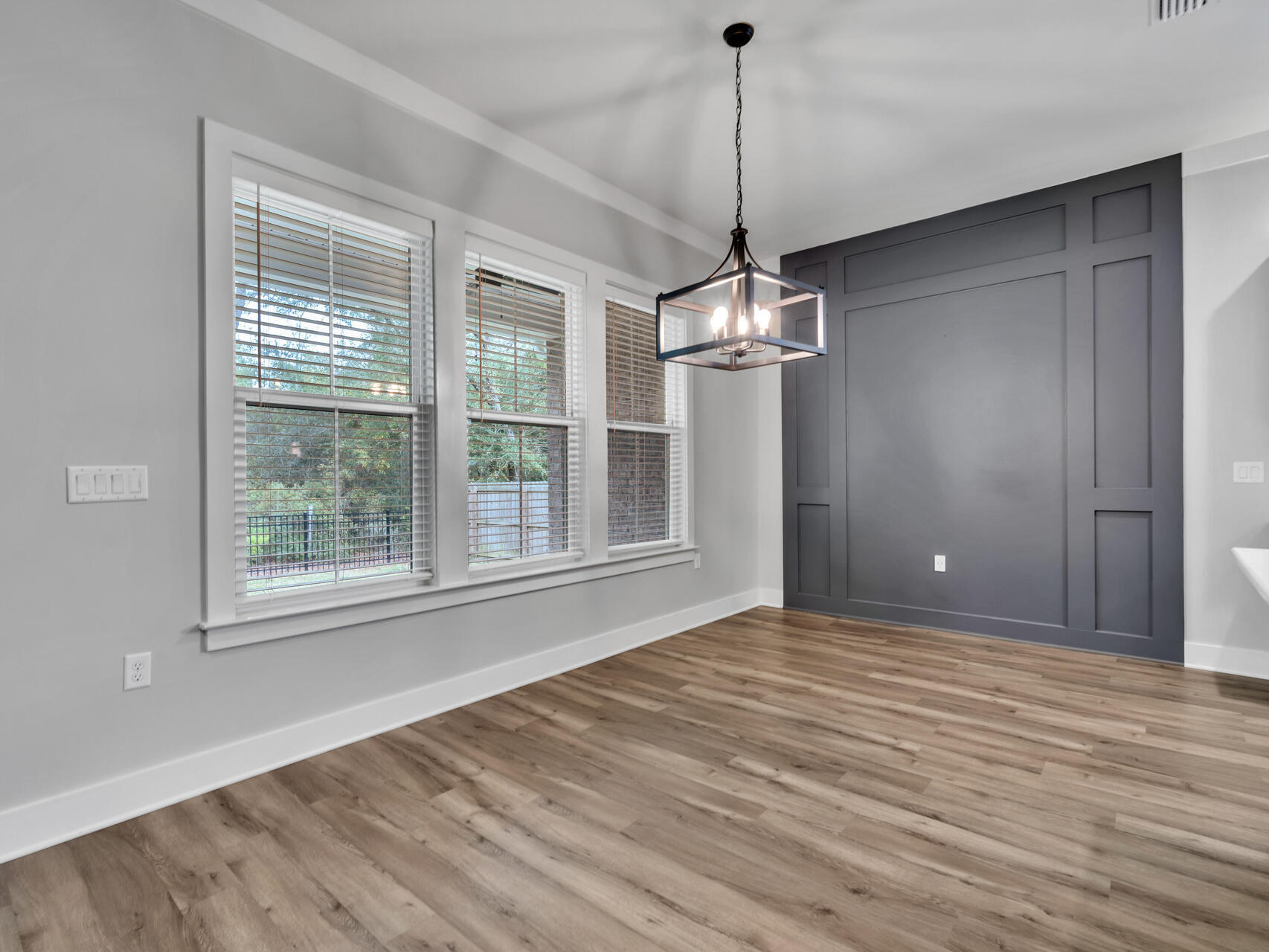 1160 Deer Moss Loop Niceville, FL 32578 - Photo 14 of 60 a view of an empty room with wooden floor and a window