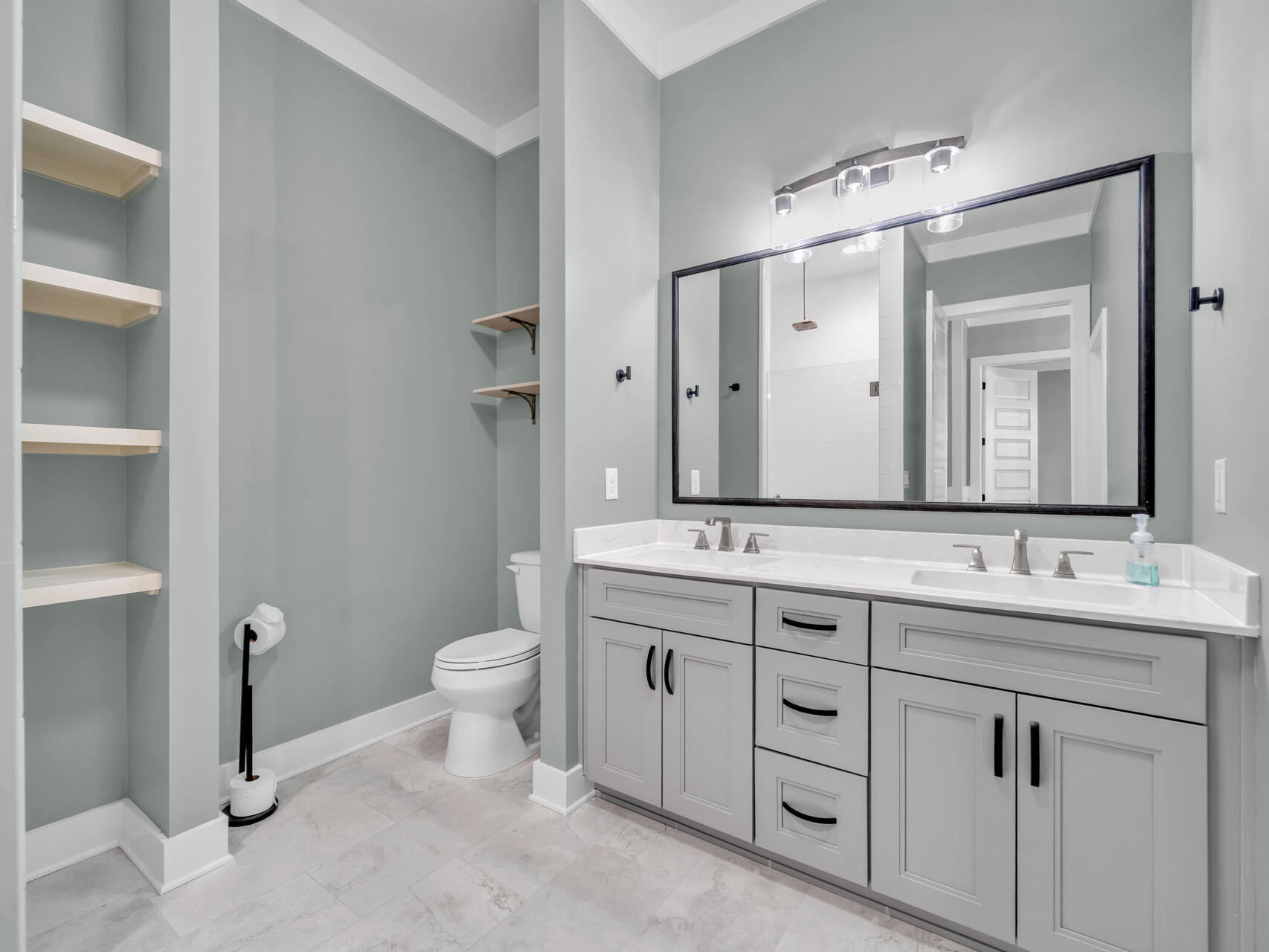 1160 Deer Moss Loop Niceville, FL 32578 - Photo 19 of 60 a bathroom with a double vanity sink toilet and a mirror