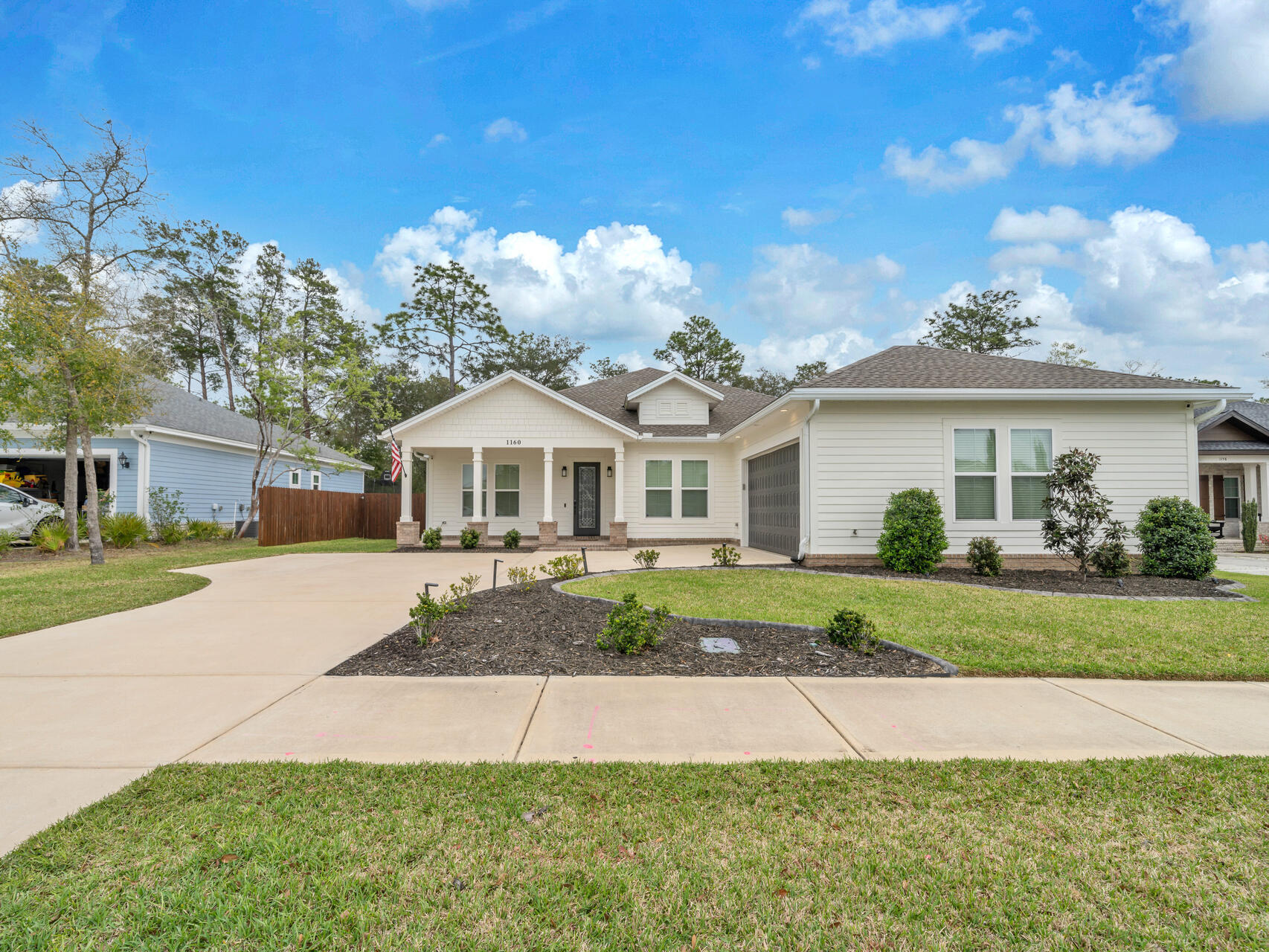 1160 Deer Moss Loop Niceville, FL 32578 - Photo 2 of 60 a front view of a house with a yard and porch