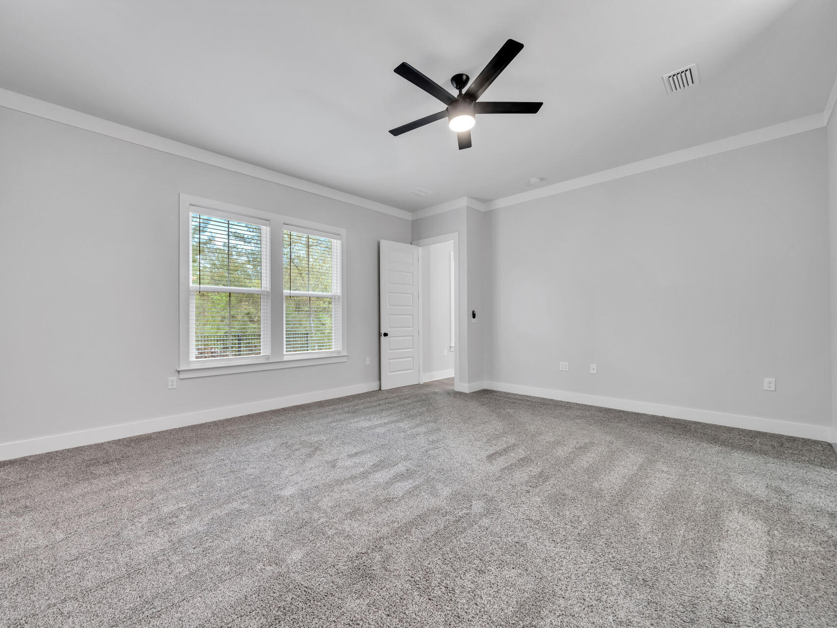 1160 Deer Moss Loop Niceville, FL 32578 - Photo 24 of 60 an empty room with ceiling fan and window