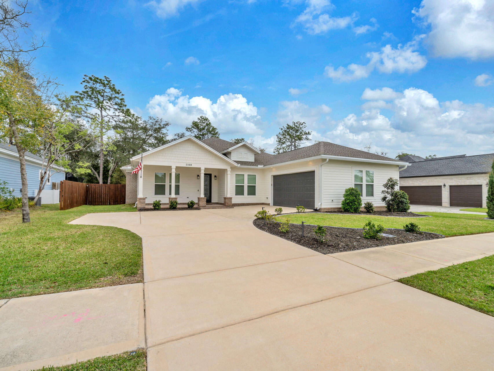 1160 Deer Moss Loop Niceville, FL 32578 - Photo 3 of 60 a front view of a house with a garden and yard