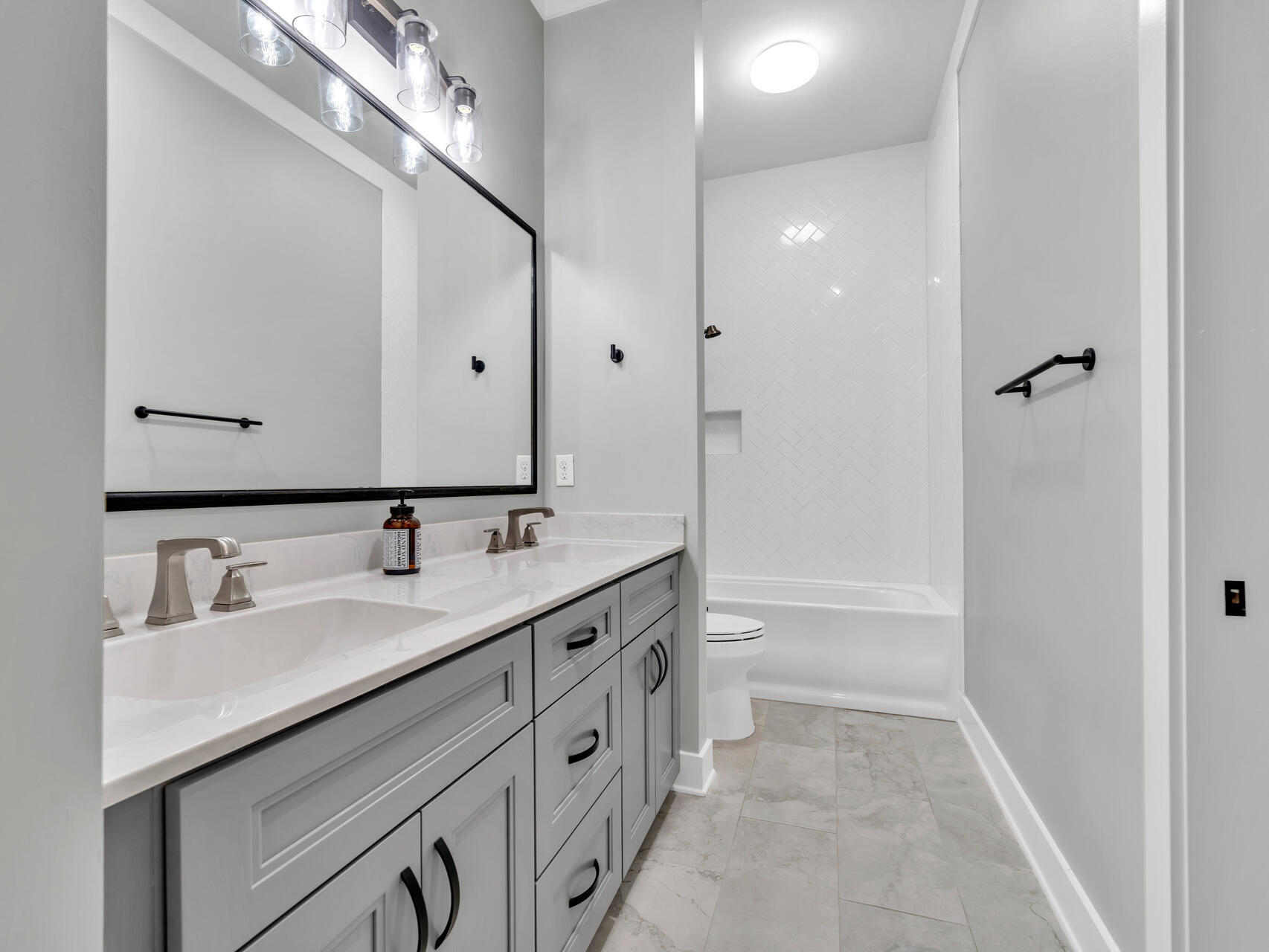 1160 Deer Moss Loop Niceville, FL 32578 - Photo 32 of 60 a bathroom with a double vanity sink mirror double and a bathtub