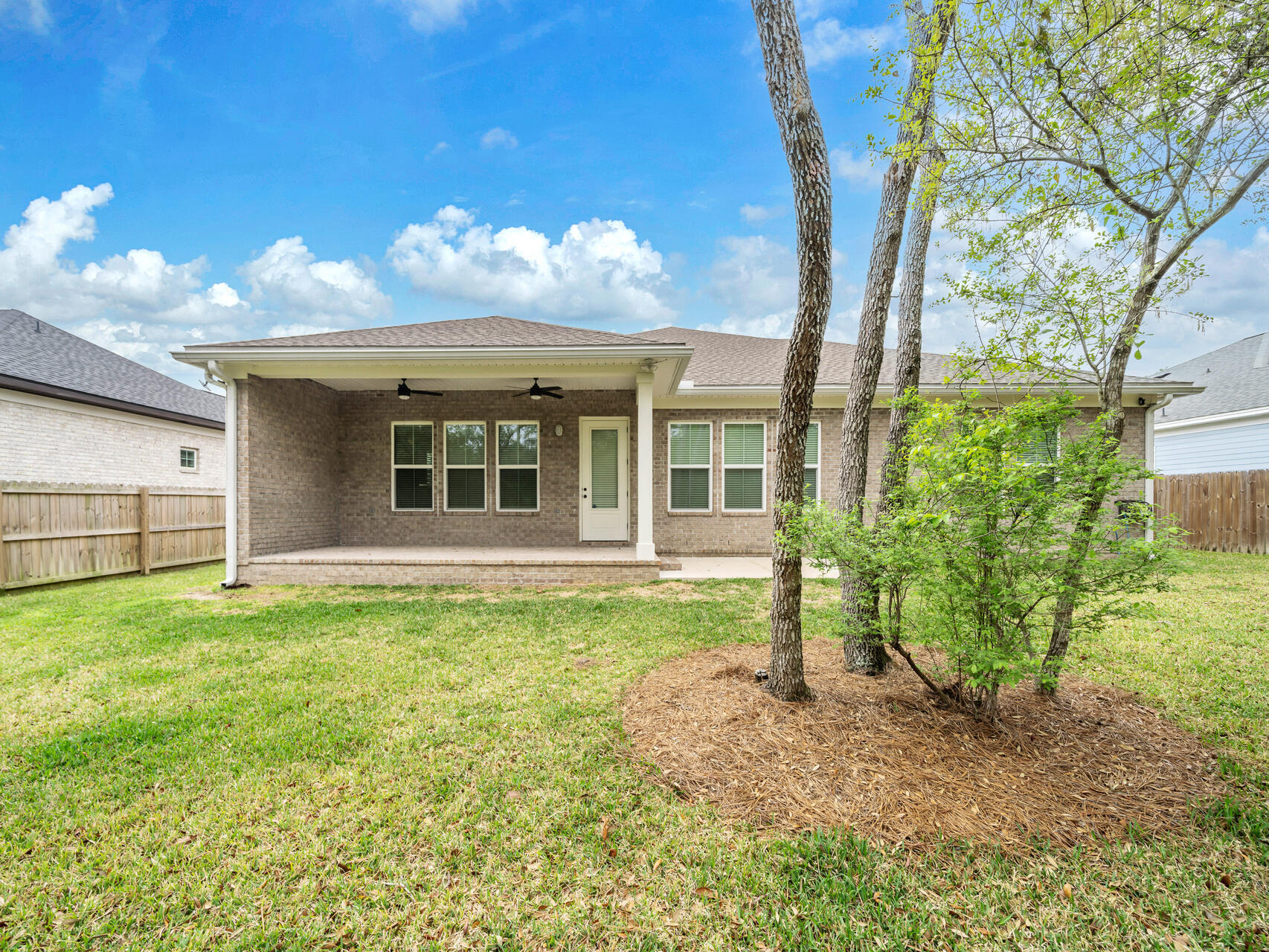 1160 Deer Moss Loop Niceville, FL 32578 - Photo 40 of 60 a view of a house with backyard and a tree