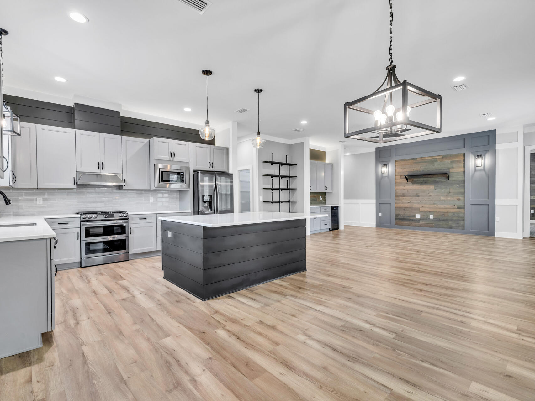 1160 Deer Moss Loop Niceville, FL 32578 - Photo 9 of 60 a large kitchen with stainless steel appliances granite countertop a stove and a refrigerator