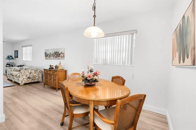 a view of a dining room with furniture and a window