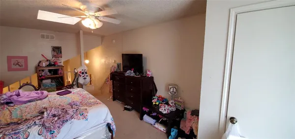 a bedroom with a bed and a tv