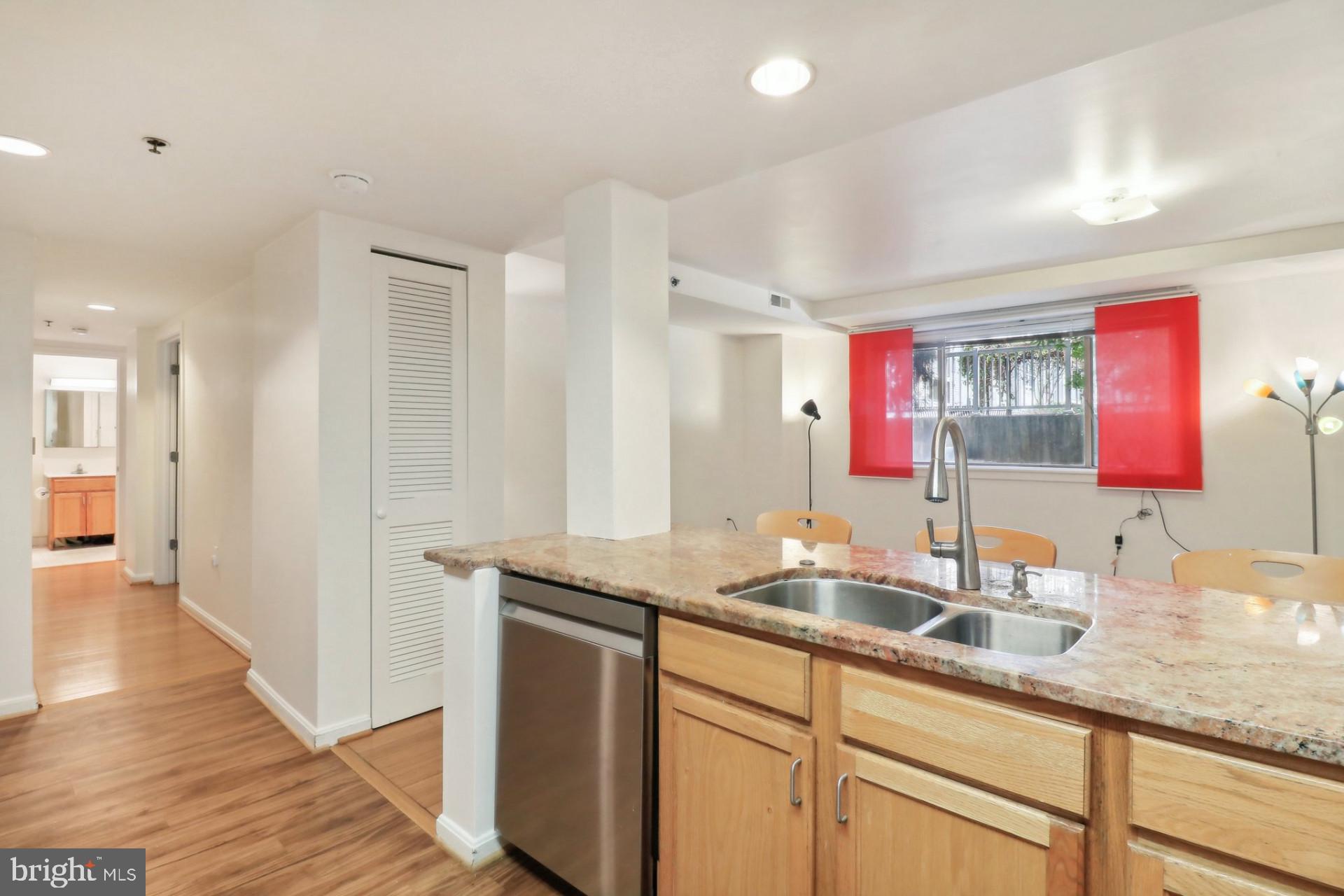 7981 Eastern Avenue Northwest, Unit 211 Silver Spring, MD 20910 - Photo 12 of 45 a bathroom with a granite countertop double vanity sink a mirror and shower
