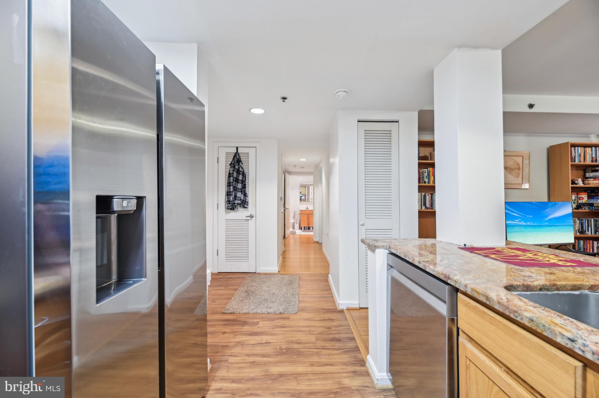 7981 Eastern Avenue Northwest, Unit 211 Silver Spring, MD 20910 - Photo 13 of 45 a view of a kitchen with stainless steel appliances granite countertop a refrigerator and a sink