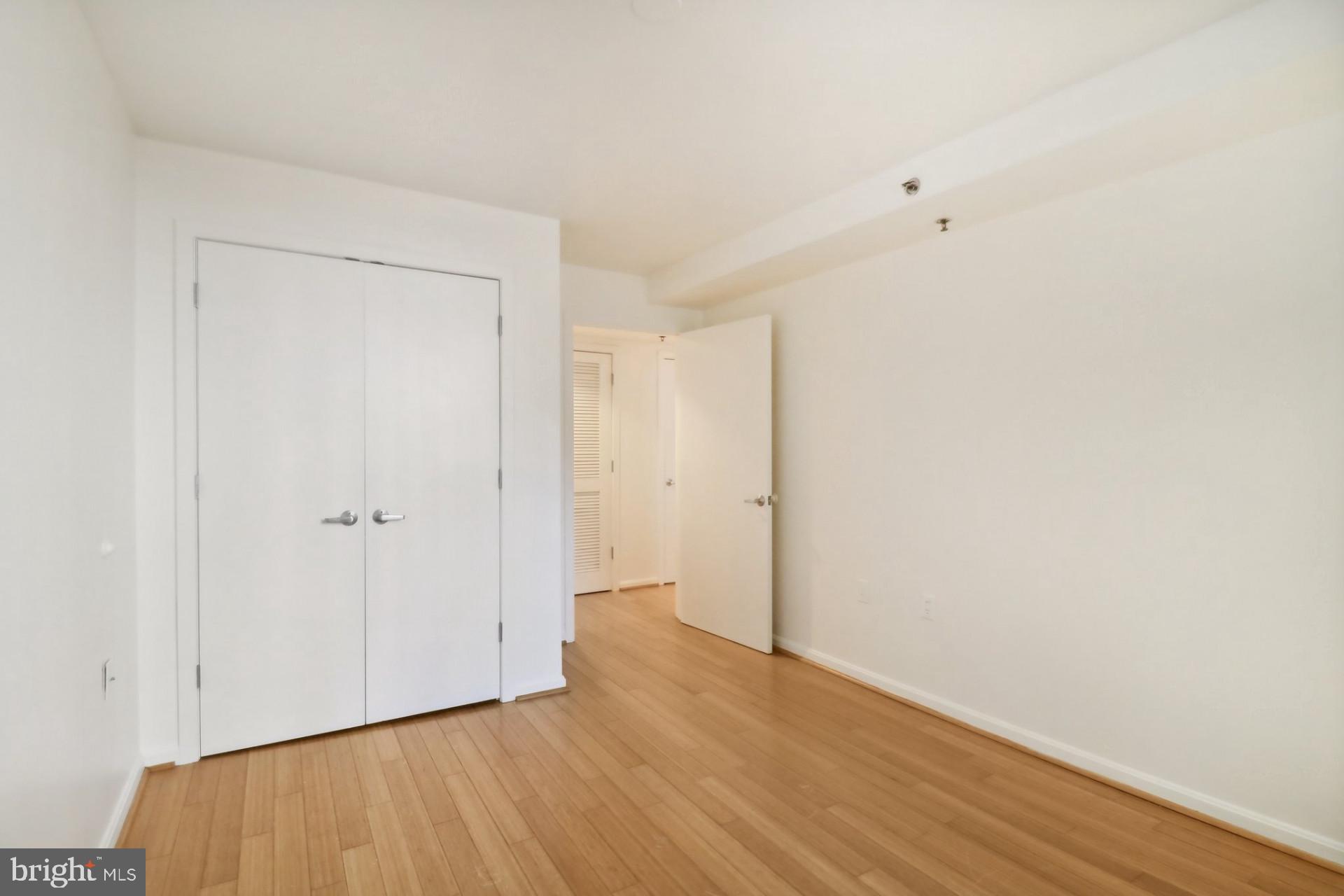 7981 Eastern Avenue Northwest, Unit 211 Silver Spring, MD 20910 - Photo 17 of 45 a view of an empty room with wooden floor