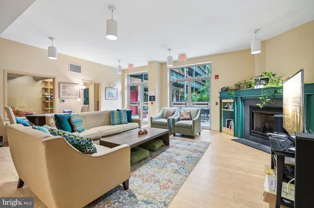 a living room with furniture large window and a fireplace
