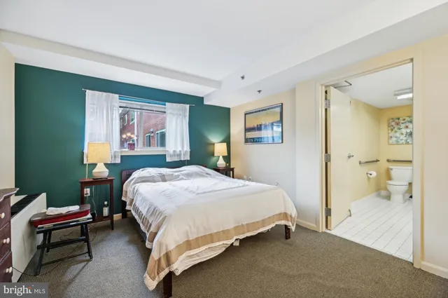 a bed room with a bed and a chair