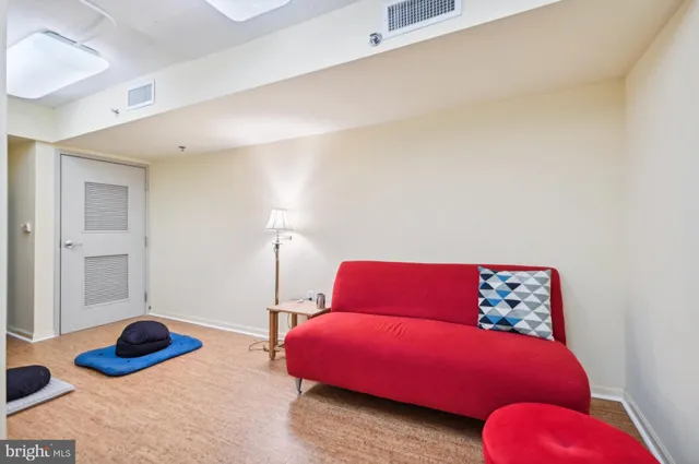a bedroom with furniture and a large window
