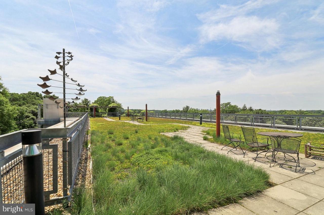 7981 Eastern Avenue Northwest, Unit 211 Silver Spring, MD 20910 - Photo 30 of 45 a view of a lake with a garden