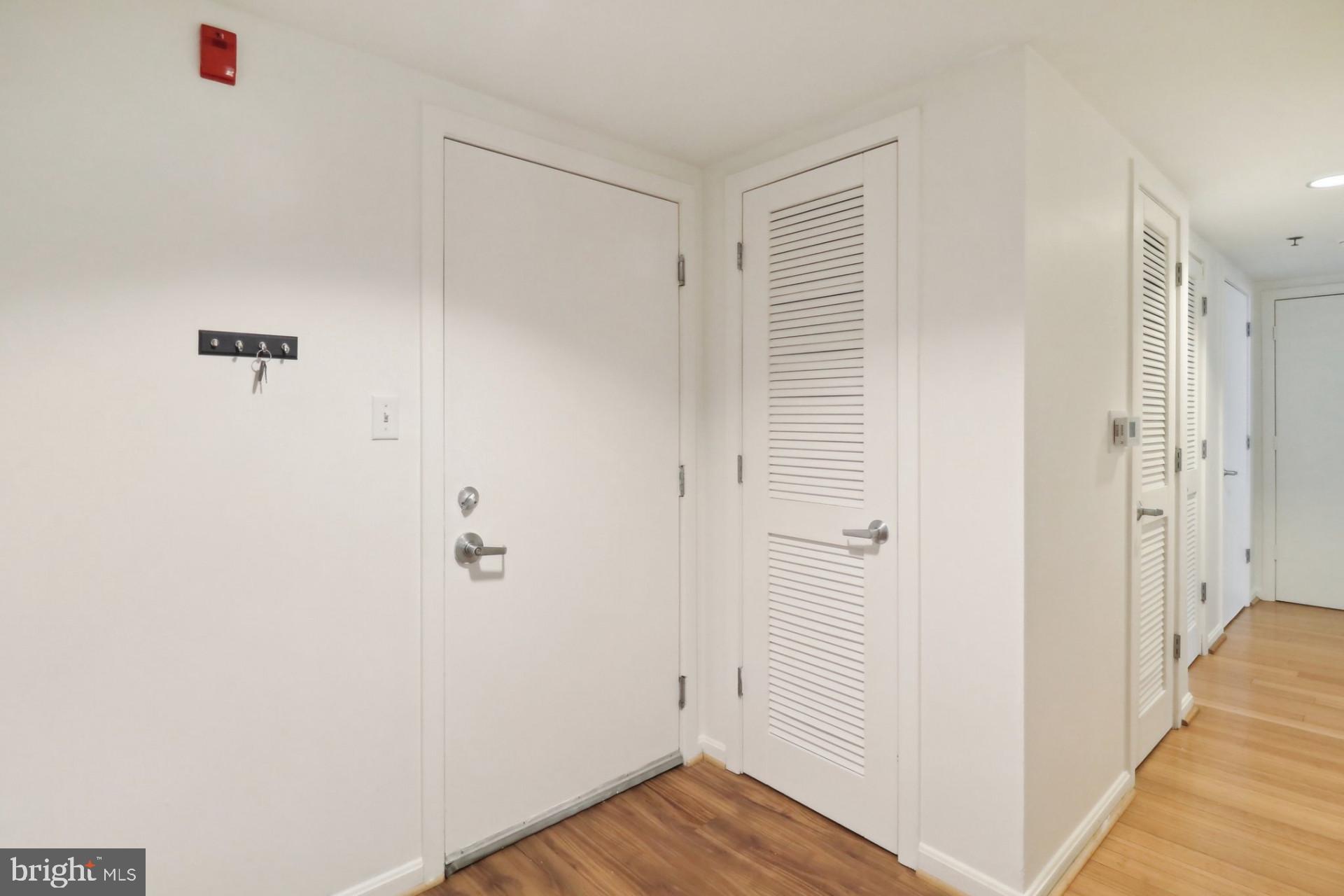 7981 Eastern Avenue Northwest, Unit 211 Silver Spring, MD 20910 - Photo 3 of 45 a view of a hallway with wooden floor