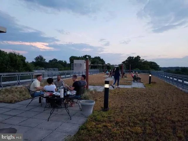 a roof deck with table and chairs