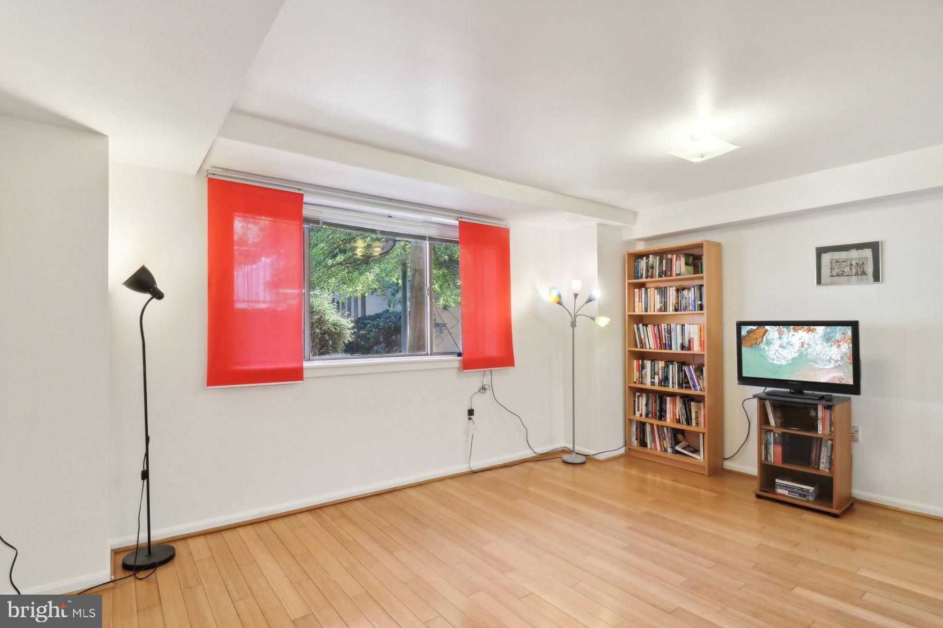 7981 Eastern Avenue Northwest, Unit 211 Silver Spring, MD 20910 - Photo 4 of 45 a workspace with furniture wooden floor and window