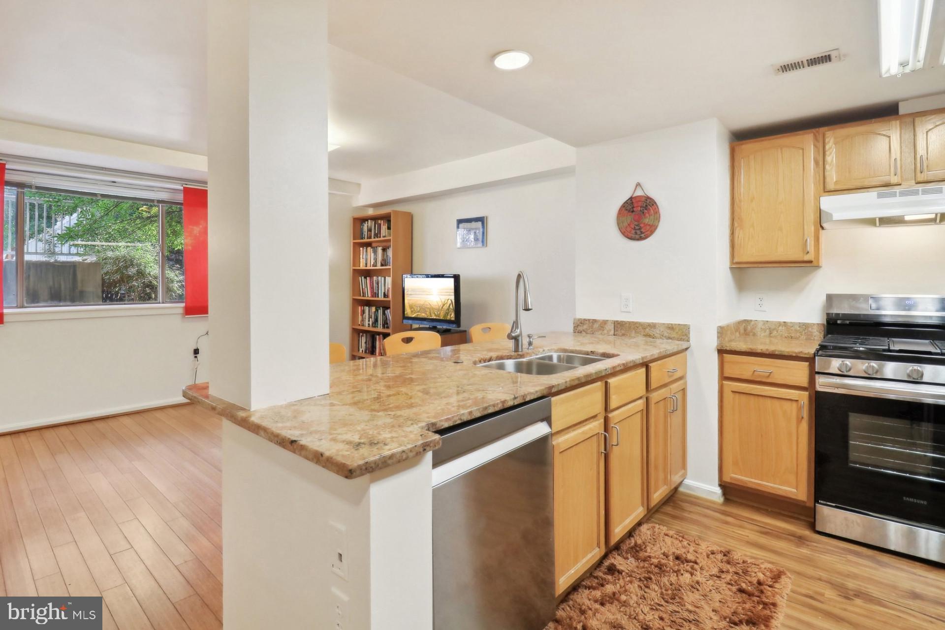 7981 Eastern Avenue Northwest, Unit 211 Silver Spring, MD 20910 - Photo 6 of 45 a kitchen with a sink stove and refrigerator