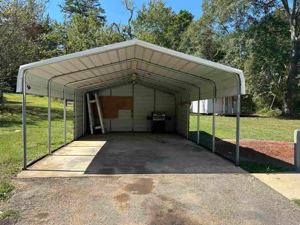 a view of a house with backyard and porch
